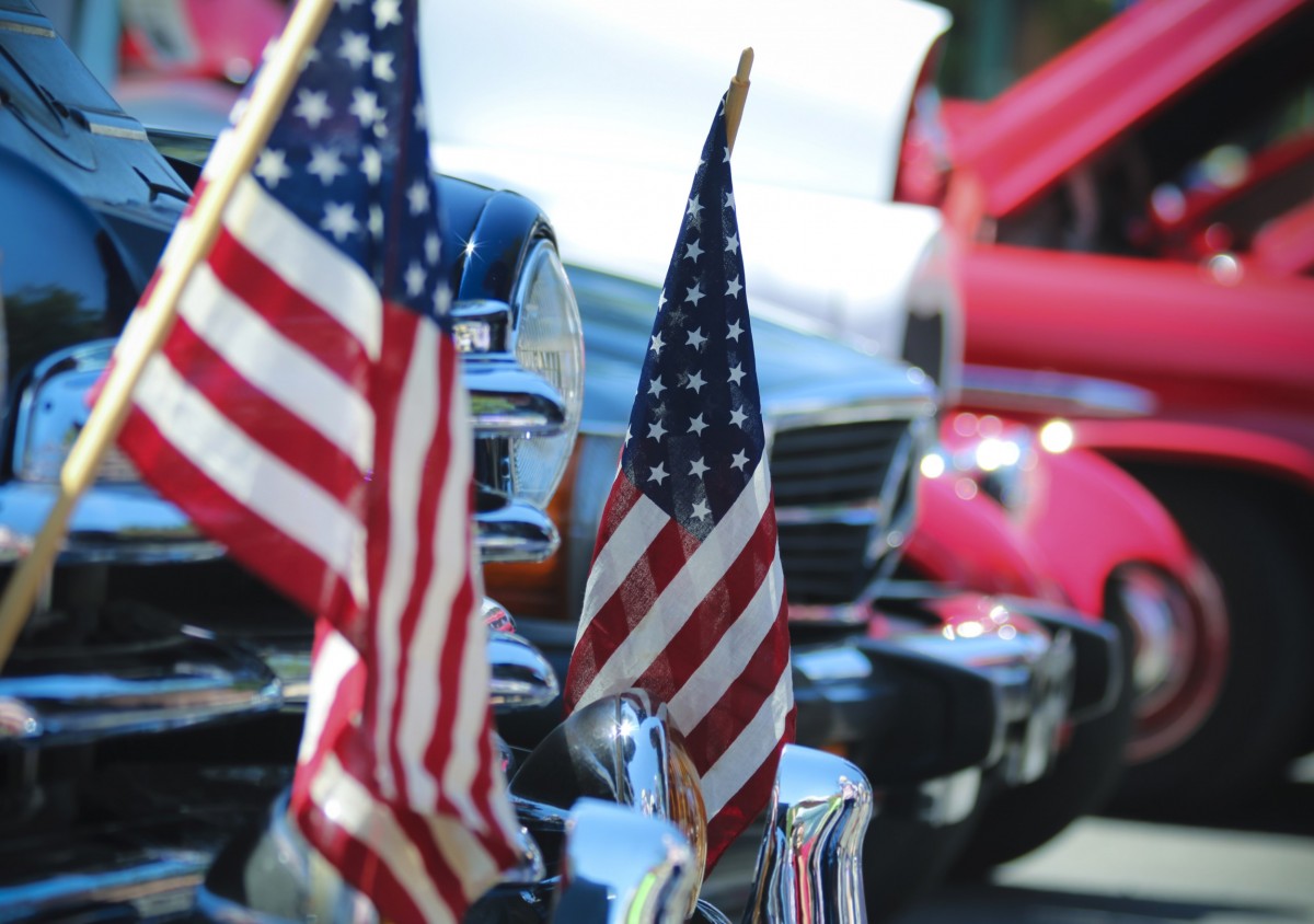 classic cars with flags on the front bumper